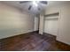 This bedroom has hardwood floors, a ceiling fan, and closet at 668 Lynn Sw Cir, Atlanta, GA 30311