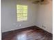 A small bedroom with hardwood floors, a window, and painted walls at 668 Lynn Sw Cir, Atlanta, GA 30311