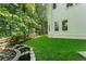 Well-maintained backyard with green grass, mature trees, and a rustic wood fence at 1575 Wynridge Pointe, Alpharetta, GA 30005