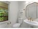 Powder room with pedestal sink and view from the window at 1575 Wynridge Pointe, Alpharetta, GA 30005