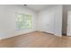 Bedroom with wood floors featuring natural light and a double closet at 1575 Wynridge Pointe, Alpharetta, GA 30005