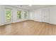 Bright bedroom featuring wood floors, two windows and a door leading to an outdoor area at 1575 Wynridge Pointe, Alpharetta, GA 30005