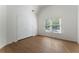 Cozy bedroom featuring wood floors, natural light, and double closets at 1575 Wynridge Pointe, Alpharetta, GA 30005