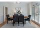 Elegant dining room features modern lighting, beautiful hardwood floors, and a large window for natural light at 1575 Wynridge Pointe, Alpharetta, GA 30005