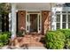 Charming front porch with brick paving, columns, and an inviting entrance leading to a beautiful home at 1575 Wynridge Pointe, Alpharetta, GA 30005