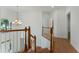 Bright upstairs landing area featuring wood floors and a wooden banister at 1575 Wynridge Pointe, Alpharetta, GA 30005