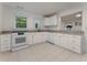 Bright kitchen with white cabinets, granite countertops, stainless steel appliances and tile floors at 1575 Wynridge Pointe, Alpharetta, GA 30005
