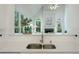 This kitchen features stainless sink, hardwood floors, white cabinets, and a view into the adjacent living room and fireplace at 1575 Wynridge Pointe, Alpharetta, GA 30005
