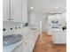 This kitchen showcases white cabinets, granite countertops, stainless appliances, and hardwood floors at 1575 Wynridge Pointe, Alpharetta, GA 30005