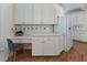 This kitchen has a built-in desk area, quartz countertop, and white cabinets at 1575 Wynridge Pointe, Alpharetta, GA 30005