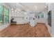 Spacious kitchen features white cabinets, hardwood floors, and a modern light fixture at 1575 Wynridge Pointe, Alpharetta, GA 30005