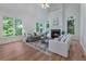 Bright living room with fireplace, hardwood floors, large windows, and ample seating for a comfortable gathering space at 1575 Wynridge Pointe, Alpharetta, GA 30005
