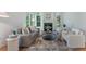 Inviting living room with a fireplace, hardwood floors, and large windows offering picturesque views of the outdoors at 1575 Wynridge Pointe, Alpharetta, GA 30005