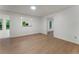 Open-concept living room featuring light wood floors and bright white walls at 1575 Wynridge Pointe, Alpharetta, GA 30005