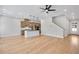 Open-concept living room features hardwood floors and connects to a modern kitchen with a center island at 2560 Silver Star Ne Dr, Marietta, GA 30066