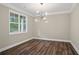 Bright dining room with hardwood floors, natural light, and a modern chandelier, perfect for Gathering gatherings at 2610 Lisa Sw Dr, Atlanta, GA 30311