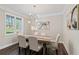 Elegant dining room featuring a stylish chandelier, wood floors, and natural light at 2610 Lisa Sw Dr, Atlanta, GA 30311
