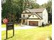 New construction home with a two-car garage, covered porch, and professionally landscaped lawn at 2610 Lisa Sw Dr, Atlanta, GA 30311