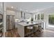 Open kitchen with stainless steel appliances, island with seating, and view to backyard at 2610 Lisa Sw Dr, Atlanta, GA 30311