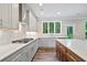 This kitchen features stainless steel appliances, white countertops, white cabinetry, and hardwood flooring at 2610 Lisa Sw Dr, Atlanta, GA 30311