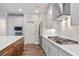 This kitchen showcases stainless steel appliances, white countertops, white cabinetry, and hardwood flooring at 2610 Lisa Sw Dr, Atlanta, GA 30311