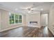 Modern living room with an electric fireplace, hardwood floors, and large windows offering scenic views at 2610 Lisa Sw Dr, Atlanta, GA 30311