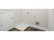 A utility room with white walls, white trim, gray flooring, and utility connections at 2610 Lisa Sw Dr, Atlanta, GA 30311