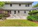 Inviting backyard with a concrete patio, white metal furniture, and lush greenery at 4774 Olde Village Ln, Atlanta, GA 30338