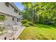 Expansive backyard featuring a well-maintained lawn, a cozy patio and mature trees that offers privacy at 4774 Olde Village Ln, Atlanta, GA 30338