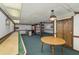 Finished basement with carpet flooring, a shuffleboard table, and ample space at 4774 Olde Village Ln, Atlanta, GA 30338
