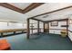 Spacious basement with carpet flooring, wood beam accents, and a walk-out door at 4774 Olde Village Ln, Atlanta, GA 30338