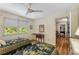 Bedroom featuring hardwood floors, a ceiling fan, and large windows with natural light at 4774 Olde Village Ln, Atlanta, GA 30338