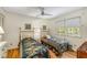 Bedroom with two twin beds, floral bedding, hardwood floors, and a ceiling fan at 4774 Olde Village Ln, Atlanta, GA 30338