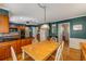 Dining area with wood floors and adjacent kitchen with dark teal walls at 4774 Olde Village Ln, Atlanta, GA 30338