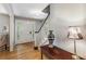 Bright foyer featuring hardwood floors, a decorative front door, and elegant stairway details at 4774 Olde Village Ln, Atlanta, GA 30338