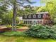 Traditional home with well-manicured landscaping, including mature trees and shrubs, enhancing curb appeal at 4774 Olde Village Ln, Atlanta, GA 30338