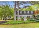 Inviting home featuring mature trees, and lush landscaping enhancing privacy and curb appeal at 4774 Olde Village Ln, Atlanta, GA 30338