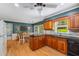 Bright kitchen features wood cabinets, granite counters, and an adjacent dining area with a ceiling fan at 4774 Olde Village Ln, Atlanta, GA 30338