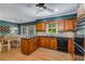Well-equipped kitchen features wood cabinets, black countertops, and stainless steel appliances at 4774 Olde Village Ln, Atlanta, GA 30338
