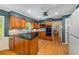 Bright kitchen with wood cabinetry, black countertops, and modern appliances at 4774 Olde Village Ln, Atlanta, GA 30338