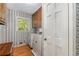 Laundry room with washer, dryer, wallpaper, storage cabinets, and natural light at 4774 Olde Village Ln, Atlanta, GA 30338