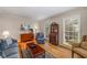 Well-lit living room featuring hardwood floors, stylish furniture, and large windows at 4774 Olde Village Ln, Atlanta, GA 30338