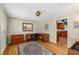Spacious home office features hardwood floors, a large desk, and lots of natural light at 4774 Olde Village Ln, Atlanta, GA 30338
