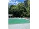 Outdoor pool area with lounge chairs and umbrellas surrounded by lush greenery at 4774 Olde Village Ln, Atlanta, GA 30338
