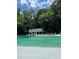Expansive community swimming pool with chairs and lifeguard stand surrounded by lush greenery at 4774 Olde Village Ln, Atlanta, GA 30338