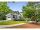 Charming home with grey painted brick, and an attached garage, surrounded by lush greenery at 4774 Olde Village Ln, Atlanta, GA 30338