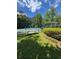 Community tennis courts with well-maintained landscaping and shaded seating areas, ideal for active lifestyles at 4774 Olde Village Ln, Atlanta, GA 30338