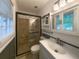 Well-lit bathroom featuring a tiled shower, vanity, and updated fixtures at 599 Honey Creek Rd, Conyers, GA 30094