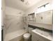 Updated bathroom with a shower-tub combo, vanity, and storage cabinet at 599 Honey Creek Rd, Conyers, GA 30094