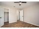 Bedroom with wood flooring, neutral paint, ceiling fan and two doorways at 599 Honey Creek Rd, Conyers, GA 30094
